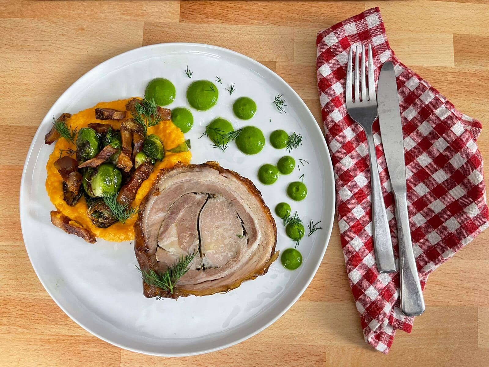 Roman Style Porchetta with guanciale, brussels sprouts, mashed sweet potatoes and salsa verde